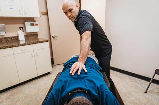 Chiropractor Portland OR Dr. Daniel Capitano Adjusting Patient Chiropractor Portland OR Dr. Daniel Capitano Adjusting Patient