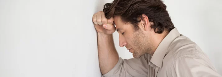 Man experiencing migraine pain needing chiropractic care