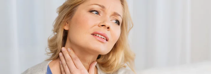 Woman with neck pain seeking chiropractic treatment