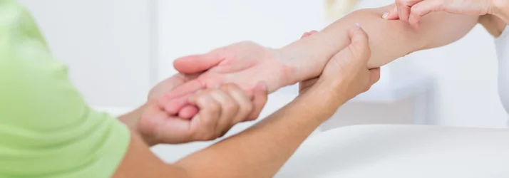 Chiropractor performing wrist adjustment for pain relief